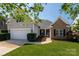 Charming two-story home with a well-manicured lawn, a two-car garage, and tasteful landscaping at 1004 Toquima Trl, Monroe, NC 28110