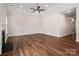 Living room with wood floors, neutral paint, ceiling fan, and fireplace at 1004 Toquima Trl, Monroe, NC 28110