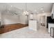 Open living space featuring wood floors, tile floors, and modern light fixture at 1004 Toquima Trl, Monroe, NC 28110