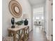 Inviting entryway featuring hardwood floors, a decorative table with lamp, and a decorative mirror at 1034 Mapletree Ln, Indian Trail, NC 28079