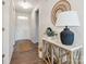Inviting entryway featuring hardwood floors, a decorative table with lamp, and a decorative mirror at 1034 Mapletree Ln, Indian Trail, NC 28079