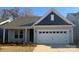 Charming one-story home features a two-car garage, lovely landscaping and craftsman details at 1034 Mapletree Ln, Indian Trail, NC 28079