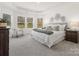 Serene main bedroom with tray ceiling, ample natural light, and contemporary decor at 1034 Mapletree Ln, Indian Trail, NC 28079