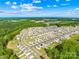 Aerial view of the community showing neighborhood layout, green spaces, and surrounding wooded area at 109 Fairfield Dr, Troutman, NC 28166