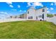 Backyard with a well-maintained lawn, patio, and white fence, providing a private outdoor space at 109 Fairfield Dr, Troutman, NC 28166