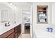 Bright bathroom with double sink vanity and framed shelf with rolled towels at 109 Fairfield Dr, Troutman, NC 28166