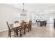 Bright dining room featuring modern lighting, light wood floors, and access to the kitchen at 109 Fairfield Dr, Troutman, NC 28166