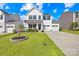 Charming two-story home with a well-manicured lawn, mature tree, and a two-car garage at 109 Fairfield Dr, Troutman, NC 28166