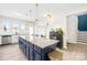 Open concept kitchen with a large island, stainless steel appliances, and seamless flow to living area at 109 Fairfield Dr, Troutman, NC 28166
