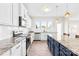 This kitchen features stainless steel appliances, granite countertops, white cabinets, and large island for entertaining at 109 Fairfield Dr, Troutman, NC 28166