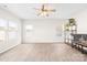 Spacious living room with ample natural light, ceiling fan, and wood-look flooring at 109 Fairfield Dr, Troutman, NC 28166