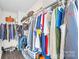 Walk-in closet with hardwood floors, wire shelves, and hanging clothes at 109 Fairfield Dr, Troutman, NC 28166