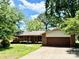 Charming single-story brick home featuring a spacious two-car garage and lush landscaping at 127 Edgeway Rd, Mooresville, NC 28117