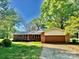 Charming single-story brick home with a well-maintained front yard and mature trees at 127 Edgeway Rd, Mooresville, NC 28117