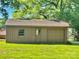Detached one car garage and out-building nestled in a serene, tree-lined backyard at 127 Edgeway Rd, Mooresville, NC 28117