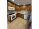 Functional kitchen with stainless steel refrigerator and classic wooden cabinets at 127 Edgeway Rd, Mooresville, NC 28117