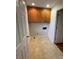 This laundry room features wood cabinets for storage and tile flooring at 127 Edgeway Rd, Mooresville, NC 28117