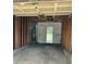 Attached garage interior shows water heater, bare walls and concrete floor leading to the back yard at 13933 Eden Ct, Pineville, NC 28134