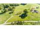 Aerial view of the property, featuring a spacious lot with gentle topography and mature trees at 153 Coachman Loop, Statesville, NC 28625