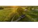 Beautiful aerial view of property showcasing the expansive green lawns and setting sun at 153 Coachman Loop, Statesville, NC 28625