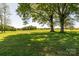 View of large backyard and surrounding trees at 153 Coachman Loop, Statesville, NC 28625