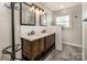 Updated bathroom featuring a double vanity, updated fixtures, and modern lighting at 153 Coachman Loop, Statesville, NC 28625