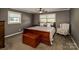 Bedroom featuring neutral colors, a wooden bed frame, and two windows at 153 Coachman Loop, Statesville, NC 28625