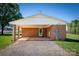 Exterior shot of the side entry car port featuring brick columns and concrete flooring at 153 Coachman Loop, Statesville, NC 28625