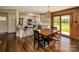 Open dining area with kitchen views featuring hardwood floors and outdoor access to a beautiful outdoor space at 153 Coachman Loop, Statesville, NC 28625