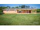 Exterior view of a brick home with a spacious backyard at 153 Coachman Loop, Statesville, NC 28625