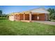 View of side of home with entry portico with brick columns and a lush lawn at 153 Coachman Loop, Statesville, NC 28625