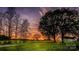 Scenic sunset over green property with mature trees and farm buildings at 153 Coachman Loop, Statesville, NC 28625