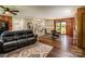 Open concept living room with hardwood floors, ceiling fan and a view into the kitchen with stainless steel appliances at 153 Coachman Loop, Statesville, NC 28625