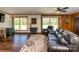 Spacious living room with hardwood floors, neutral walls, bright windows, and comfortable furnishings at 153 Coachman Loop, Statesville, NC 28625