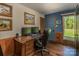 Well-lit home office featuring a wood desk, hardwood floors, and natural light at 153 Coachman Loop, Statesville, NC 28625