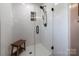 Modern shower featuring a glass door, bench, and tiled walls at 153 Coachman Loop, Statesville, NC 28625