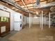 Open basement area with washer and dryer hookups and utility access at 1596 Clayton Dr, Charlotte, NC 28203