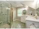 Well-lit bathroom features dual sinks, tiled floors, glass shower and a large mirror at 1596 Clayton Dr, Charlotte, NC 28203