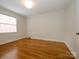Bedroom with hardwood floors and a window with white blinds to allow for natural light at 1596 Clayton Dr, Charlotte, NC 28203