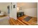 Light-filled bonus room features a display case, hardwood floors, and a cozy seating area, perfect for relaxation at 1596 Clayton Dr, Charlotte, NC 28203