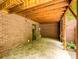 Brick carport featuring a door to the home and paved flooring at 1596 Clayton Dr, Charlotte, NC 28203