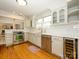 Well-lit kitchen with stainless steel appliances, white cabinets, subway tile backsplash and wood floors at 1596 Clayton Dr, Charlotte, NC 28203