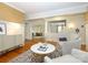 Cozy living room with neutral colors, hardwood floors, a decorative rug and a glimpse of the staircase at 1596 Clayton Dr, Charlotte, NC 28203