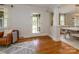 Bright living room with hardwood floors, a glass paneled door, and views of the dining area at 1596 Clayton Dr, Charlotte, NC 28203