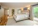 Bright main bedroom showcases a king bed, wood floors and a walkout balcony to enjoy outdoor living at 1596 Clayton Dr, Charlotte, NC 28203