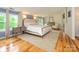 Spacious main bedroom boasts wood floors, a plush rug, and a king bed, creating a luxurious and comfortable retreat at 1596 Clayton Dr, Charlotte, NC 28203