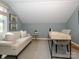 Cozy home office includes a comfortable sofa, desk and window with beautiful light at 1596 Clayton Dr, Charlotte, NC 28203