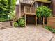 Spacious brick patio with wooden stairs, a wooden deck, and a charming outdoor setting at 1596 Clayton Dr, Charlotte, NC 28203