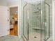 Modern bathroom with a glass enclosed shower featuring tiled walls, a built-in seat, and updated fixtures at 1596 Clayton Dr, Charlotte, NC 28203