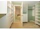 Custom walk-in closet offers generous storage, with built-in shelves and drawers for an organized wardrobe at 1596 Clayton Dr, Charlotte, NC 28203